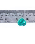 1.26 ct. heart cut Colombian emerald with vibrant bluish-green color, shown next to a ruler for scale.