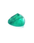 1.26 ct heart cut Colombian emerald with vibrant bluish-green color on a white background.