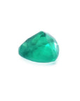 1.26 ct heart cut Colombian emerald with vibrant bluish-green color on a white background.