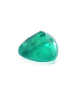 1.26 ct heart cut Colombian emerald with vibrant bluish-green color on a white background.