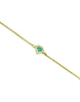 14K yellow gold bracelet with a heart-shaped emerald surrounded by sparkling diamonds.