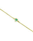 14K yellow gold bracelet with a heart-shaped emerald surrounded by sparkling diamonds.