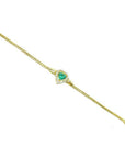14K yellow gold bracelet with a heart-shaped emerald surrounded by sparkling diamonds.