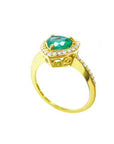 From a partial side angle perspective, a heart cut emerald engagement ring halo diamonds 14k yellow gold.