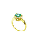 Heart-cut emerald ring with diamond halo and pavé band in 14K yellow gold.
