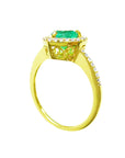 A heart cut emerald engagement ring halo diamonds 14k yellow gold. on a white background.
