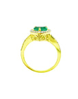Heart-cut emerald engagement ring with diamond halo and 14K yellow gold band.