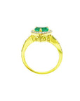 Heart-cut emerald engagement ring with diamond halo and 14K yellow gold band.