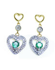 Front position of a pair of heat shaped earrings with round cut emeralds, top view.