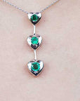 Round cut natural emeralds journey necklace heart pendant.