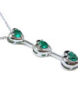 A three links heart shaped journey pendant with round cut emeralds top and side profile view.