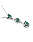 14K white gold heart journey pendant necklace with three round-cut Colombian emeralds.