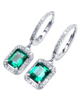 Pair of natural Colombian emerald hoop earrings, halo diamond, from the left side view, visible tp and profile.