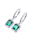 14k white gold hoop earrings with medium deep green emerald dangle, framed by natural diamonds.