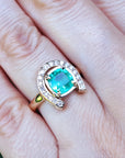 A closer view of a 1.48 ct. horseshoe emerald ring for women crafted in 14k yellow gold on a person's finger.