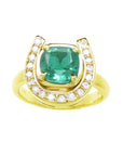 The front view of this horseshoe emerald ring displays a cushion-cut emerald framed by a semicircle of diamonds, in yellow gold.