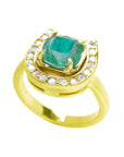 A cushion cut natural emerald on top of a horseshoe ring yellow gold.