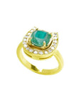 14K yellow gold horseshoe ring with a cushion-cut emerald and surrounding diamonds.