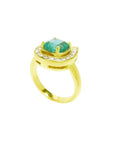 14K yellow gold horseshoe ring with cushion-cut emerald and semicircular diamond halo.