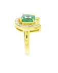 The side profile view of a horseshoe emerald ring for women crafted in 14k yellow gold.