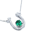Real women's emerald horseshoe necklace with natural diamonds, crafted in 14k white gold, a lucky piece of jewelry to wear every day
