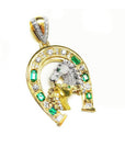 A 18k yellow gold horseshoe pendant for men with two horse's heads, natural colombian emeralds and diamonds.