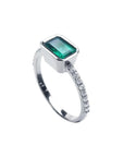 14K white gold ring with a bezel-set rectangular emerald and prong-set accent diamonds.