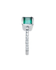 14K white gold ring with a bezel-set emerald and prong-set accent diamonds on the band.