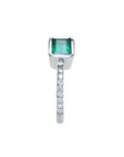 14K white gold ring with a bezel-set emerald and prong-set accent diamonds on the band.