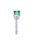 14K white gold ring with a bezel-set emerald and prong-set accent diamonds on the band.