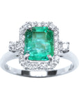 This inexpensive emerald engagement ring with a halo diamond displays the topside view.
