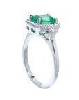 From a partial side angle, this emerald ring reveals the top setting, a portion of the gallery, and the band design.