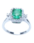 The top and band ring perspective of an emerald engagement ring with a halo diamond.