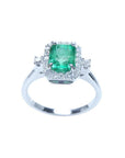 1.47 ct emerald cut emerald ring with diamond halo in 14K white gold.