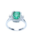 1.47 ct emerald cut emerald ring with diamond halo in 14K white gold.