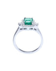14K white gold engagement ring with emerald cut emerald and diamond halo.