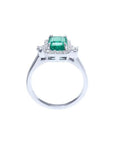 14K white gold engagement ring with emerald cut emerald and diamond halo.
