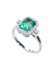 1.47 ct emerald cut emerald ring with diamond halo in 14K white gold.