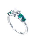 The half side position of this ring shows the top diamond and side emeralds profile.