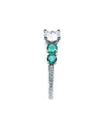 14K white gold ring with a round diamond and two side emeralds.