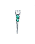 14K white gold ring with a round diamond and two side emeralds.