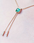 Muzo Lariat emerald necklaces for sale crafted in 14k yellow gold fine emerald-cut sourced from the Muzo mines