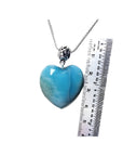 Heart-shaped blue and white larimar pendant on a sterling silver necklace, shown next to a ruler for scale.