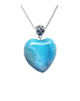 Heart-shaped blue and white larimar pendant with a decorative sterling silver bail on a silver chain.