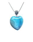 Heart-shaped blue and white larimar pendant with a decorative sterling silver bail on a silver chain.
