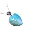 Heart-shaped blue and white larimar pendant with a decorative sterling silver bail on a silver chain.