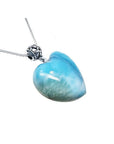 Heart-shaped blue and white larimar pendant with a decorative sterling silver bail on a silver chain.
