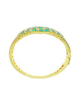 14K yellow gold bangle bracelet with round cut Colombian emeralds and diamonds in a floral design.