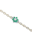 14K yellow gold chain bracelet with a central flower-shaped cluster of six green emeralds and one diamond.