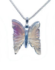 Butterfly-shaped agate silver pendant on a topside view